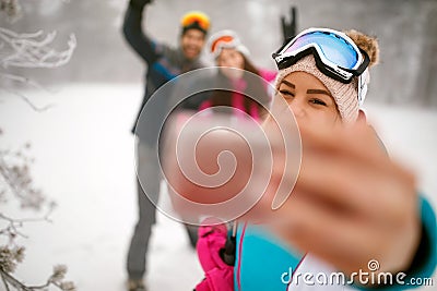 Friends making winter selfie in the mountain on winter holiday Stock Photo