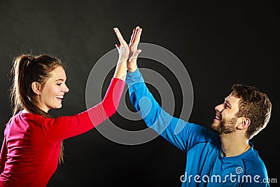 Friends man and woman celebrating giving high five Stock Photo