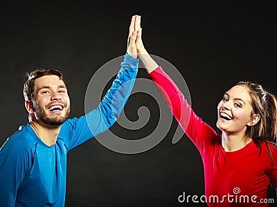 Friends man and woman celebrating giving high five Stock Photo