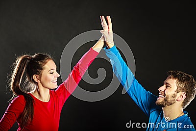 Friends man and woman celebrating giving high five Stock Photo