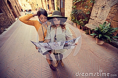 Friends with map in the city. Two girls travel together Stock Photo
