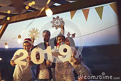 Friends at a New Year`s Eve outdoor pool party Stock Photo