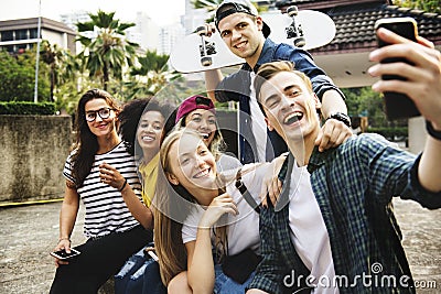 Friends in the park taking a group selfie millennial and youth c Stock Photo