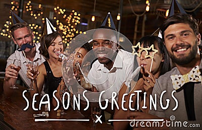 Friends at a party in a bar with Seasons Greetings message Stock Photo