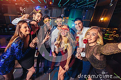 Friends partying in a nightclub make selfie photo Stock Photo