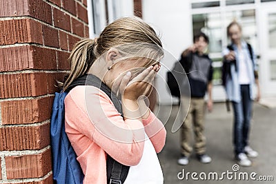 Friends at a playground bullying about other girl in foreground Stock Photo