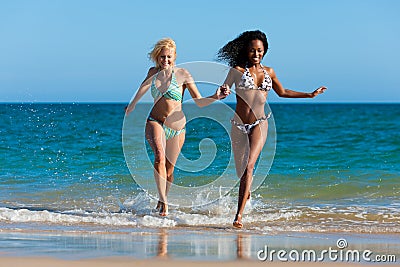 Friends running on beach vacation Stock Photo