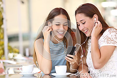 Friends sharing and listening to music with smartphone Stock Photo