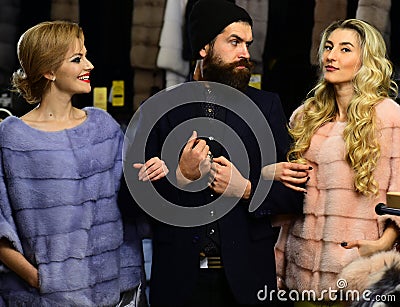 Friends in shop: ladies and gentleman in expensive overcoats. Stock Photo