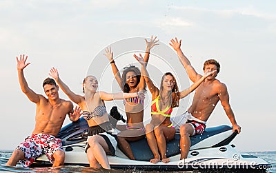 Friends sitting on a jet ski Stock Photo