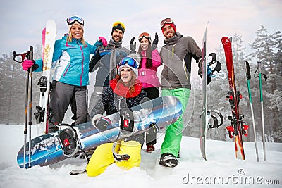 friends with ski and snowboard on winter holidays - Skiers having fun on the snow Stock Photo