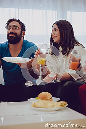 Friends smiling while holding juices Stock Photo