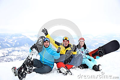 Friends with snowboards at resort. Winter vacation Stock Photo