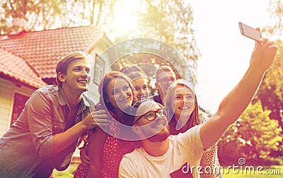 Friends taking selfie at party in summer garden Stock Photo