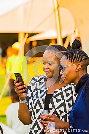 Friends taking a selfie photo at food and wine festival Editorial Stock Photo