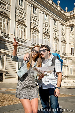 Friends tourist couple visiting Madrid in holidays visiting town happy with city map Stock Photo