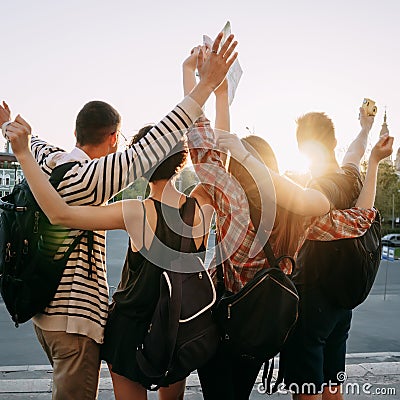 Friends tourists with backpacks rising hands Stock Photo