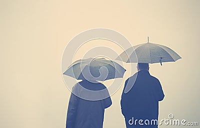 Friends under an umbrellas Stock Photo