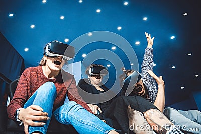 Friends in virtual glasses watching movies in the cinema with sp Stock Photo