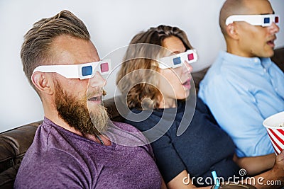 Friends watching 3D movie together Stock Photo