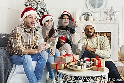 Friends watching movie and having fun at Christmas eve. Stock Photo