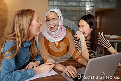 Friends. Women Meeting In Cafe. Three Young Girls With Laptop Working At Bistro. Diversity Female Having Fun In Restaurant. Stock Photo