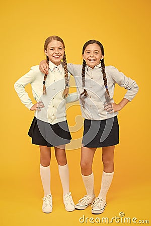 Friendship begins with smile. Happy schoolgirls enjoying bonds of friendship. Little children celebrating friendship day Stock Photo