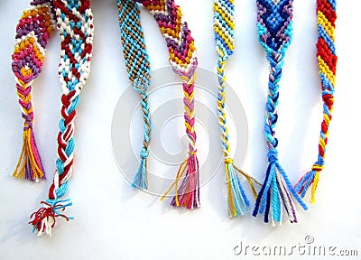 Friendship bracelets made of thread with braids on white background Stock Photo