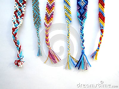 Friendship bracelets made of thread with braids on white background Stock Photo