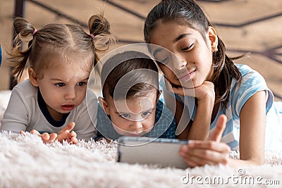 Friendship, childhood, technology concepts - 3 young children baby of different nationalities Persian and Slavic Stock Photo