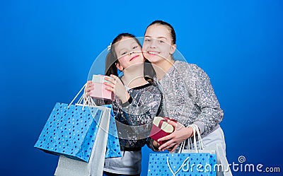 Friendship. Kid fashion. shop assistant with package. Sisterhood. Holiday purchases. Small girls with shopping bags Stock Photo
