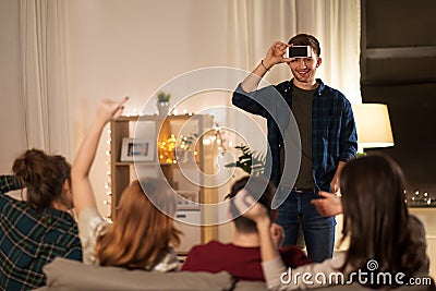 Friends playing guessing game at home in evening Stock Photo