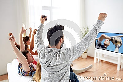 Friends watching football or soccer game on tv Stock Photo