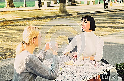 Friendship meeting. Female friendship. Trustful communication. Girls friends drink coffee and talk. Conversation of two Stock Photo