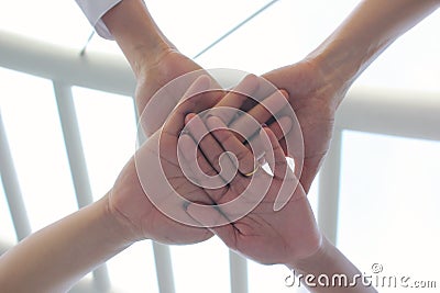 Friendship,Meeting teamwork concept,Group people with stack of hands showing unity on natural green background Stock Photo