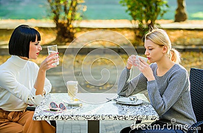 Friendship sisters. Friendship meeting. Female leisure. Girls friends drink coffee talk. Conversation women cafe terrace Stock Photo