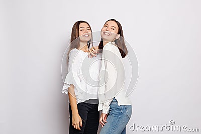 Two laughing girls in white blank t-shirts looking into the camera Stock Photo
