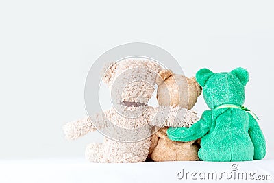 Friendship -three teddy bears holding in one`s arms Stock Photo