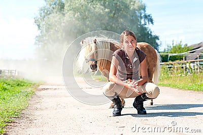 Friendship and trusting. Smiling teenage girl with little shetland pony. Stock Photo