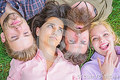 Friendship through whole life. Company friends lay grass top view. Blonde or brutal hipster friends same wave. Diversity Stock Photo