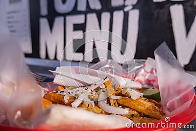 Fries and onions on a plastic basket with words behind it Stock Photo