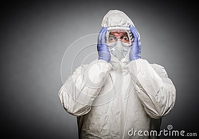 Frightened Man Holding Head With Hands Wearing HAZMAT Protective Clothing A Stock Photo