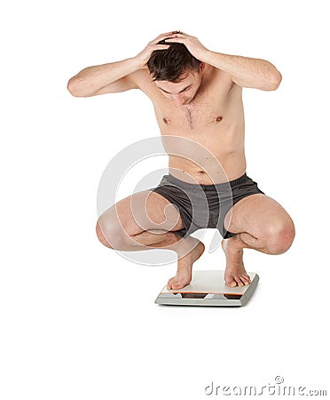 Frightened man on scale Stock Photo
