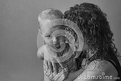 Frightened mother hugs her little son, the theme of domestic violence Stock Photo