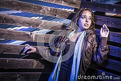 Frightened Pretty Young Woman in Dark Walkway at Night Stock Photo