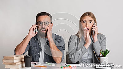 Frightened and shocked man with beard and glasses and with open mouths in workplace Stock Photo