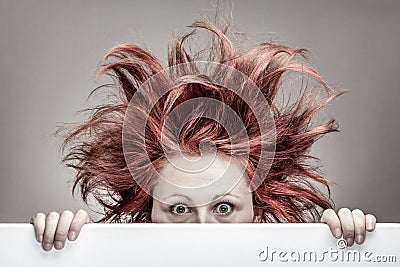 Frightened woman with messy hair Stock Photo