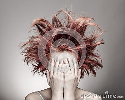 Frightened woman with messy hair Stock Photo