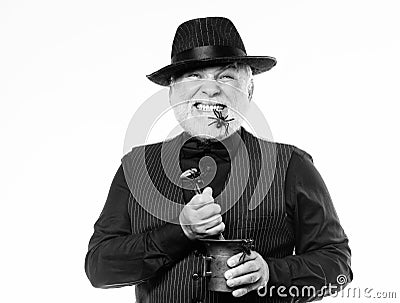 Frightening bartender. Weird old bartender with gray beard and spider. Preparing magic drink. Halloween concept. Strange Stock Photo