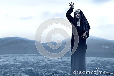 Frightening devil nun on the spooky hills Stock Photo